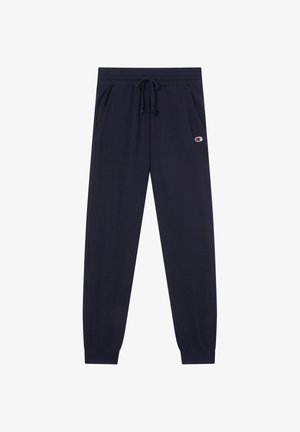 Granatowe spodnie dresowe z elastycznym pasem, sznurkiem do regulacji, bocznymi kieszeniami, ściągaczami przy nogawkach oraz logo Champion na lewej udzie.