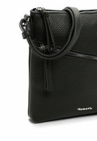 Zwarte leren handtas met een gestructureerd oppervlak, ritssluiting en een afneembare band. Heeft een strak ontwerp en zilveren logo-accent.