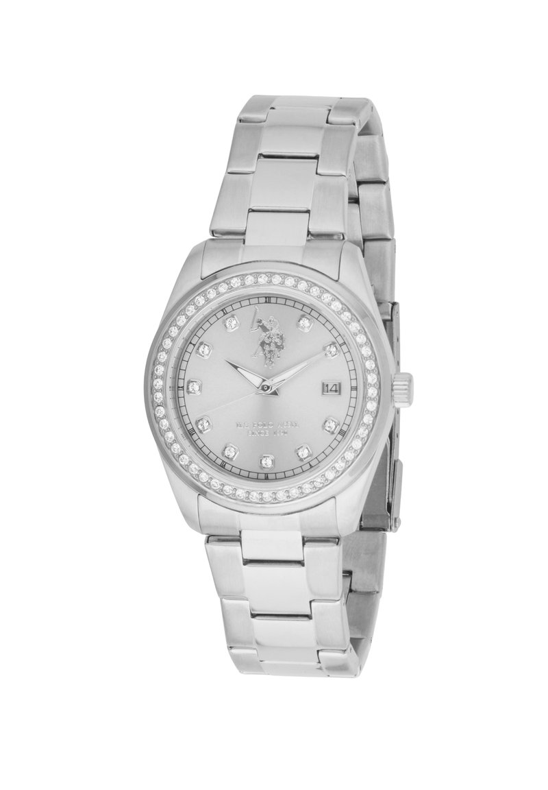 Montre en métal argenté avec un cadran rond, ornée de cristaux transparents, dotée d'un affichage de date et d'un bracelet à maillons.