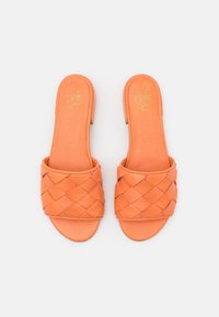 Orange leather slide sandals with a woven strap design, featuring a smooth texture and flat sole. The insole has gold branding.