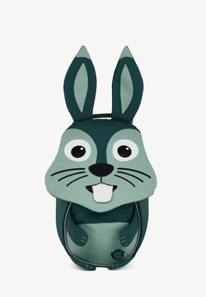 Teal rabbit-shaped backpack featuring large eyes, prominent ears, and stitched whiskers. Made from durable fabric with contrasting logo.