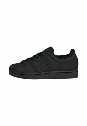 Black athletic sneakers with a rubber sole, featuring a textured toe cap, three stripe design on the side, and lace-up closure.