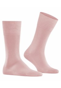 Chaussettes de couleur rose clair avec une bordure côtelée. Fabriquées dans un matériau doux, présentant un design de pointe sans couture et une texture minimaliste. Convient pour un usage décontracté.
