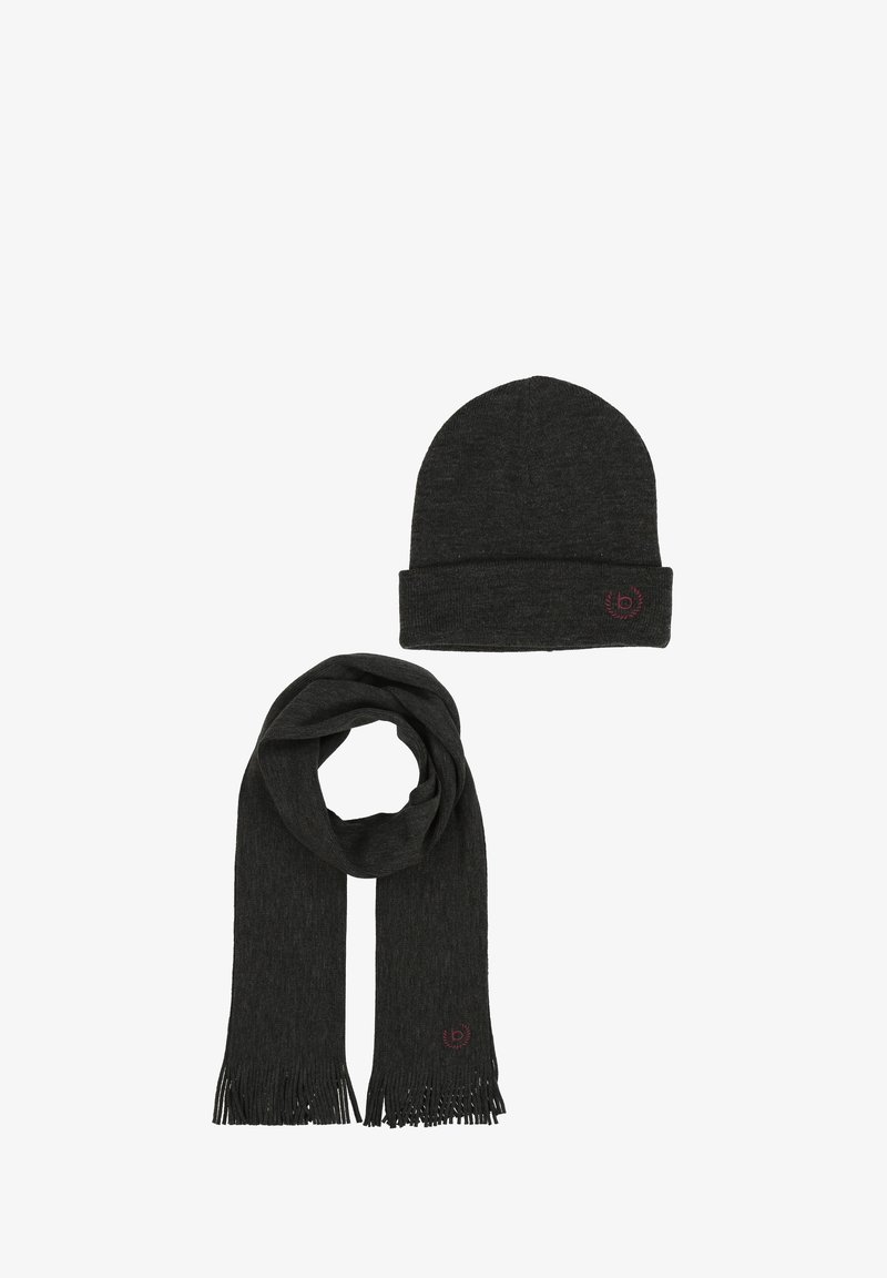 Tamsiai pilka megzta kepurė su atlenktu kraštu ir siuvinėta logo; derančios tamsiai pilkos spalvos šalikas su kutais ir subtilia tekstūra.