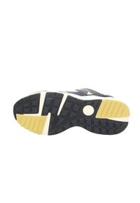 Gummisneaker-Sohle in Dunkelblau und Creme mit strukturiertem Muster, das Rillen und kreisförmige Akzente aufweist, um den Halt und die Unterstützung zu verbessern.