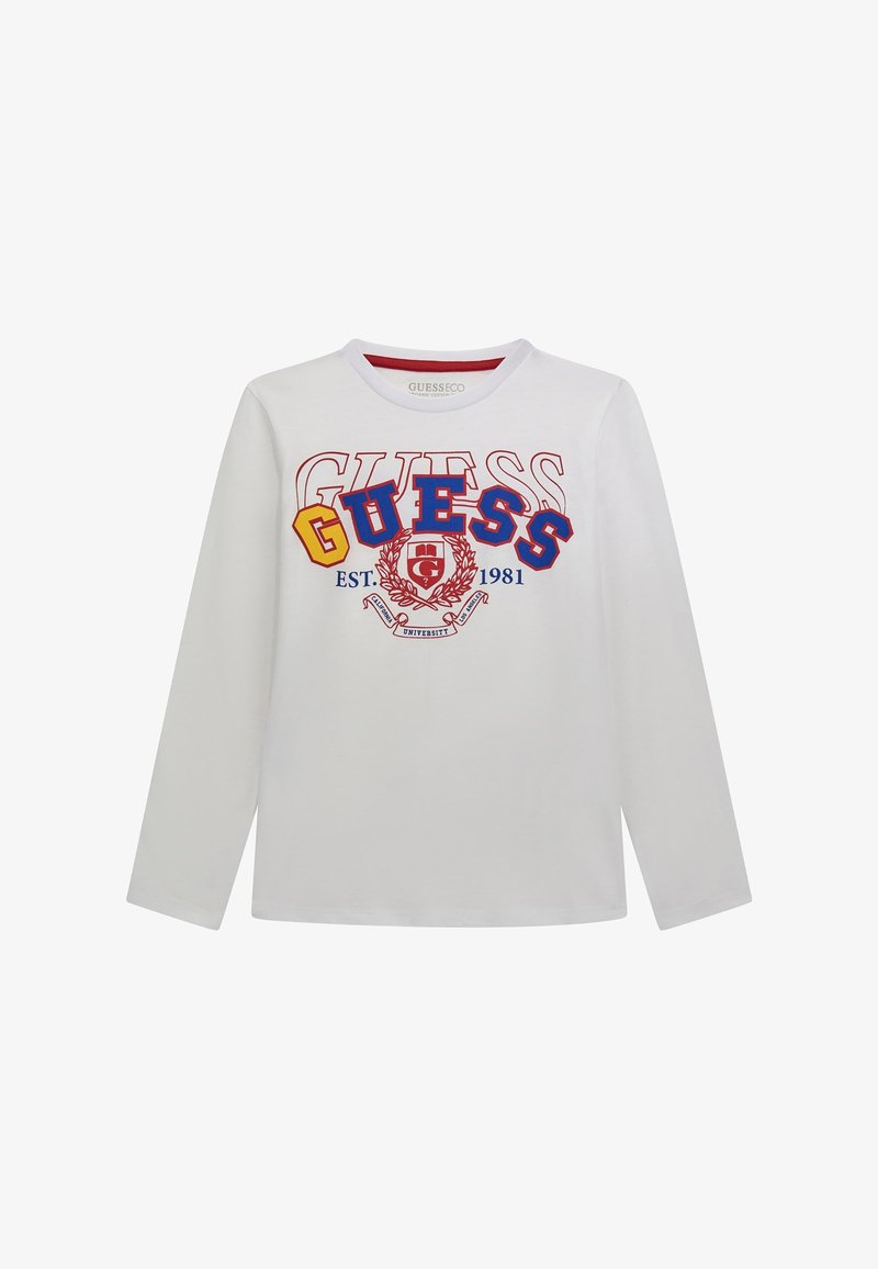 Camicia bianca a maniche lunghe con scollatura rotonda. Presenta una grafica e un emblema colorati "GUESS" con testo e elementi di design in rosso, blu e giallo.