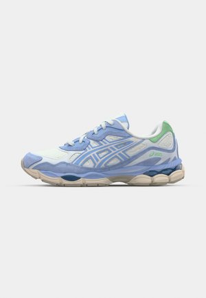 Light blue running shoe with a textured upper, mesh panels, white accents, and beige sole. Features laces and a green heel tab.