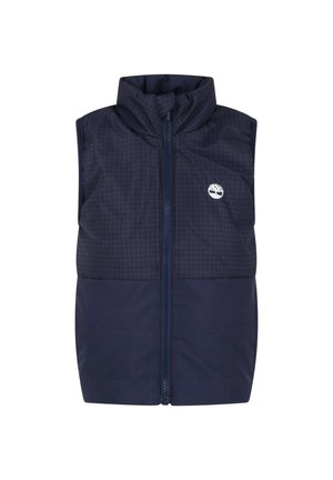 Veste matelassée sans manches bleu marine avec col haut, fermeture éclair intégrale à l'avant et logo arbre blanc sur la partie supérieure gauche de la poitrine.