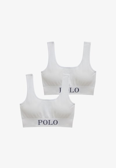 Bralettes de algodón blanco con textura acanalada, escotes cuadrados y tirantes anchos. Presentan el logo "POLO" en azul marino en la banda elástica.