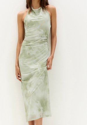 Light green, mid-length dress with a halter neckline, ruched side detail, and a soft, smooth texture featuring a subtle marbled pattern.