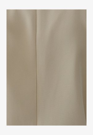 Tissu beige avec une texture lisse, présentant un détail de couture courant verticalement. Le matériau a un motif de tissage subtil.