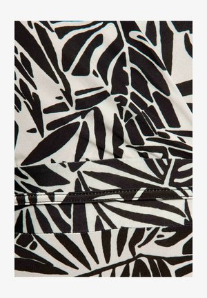 Black and white fabric with abstract leaf pattern and visible stitching along a seam.