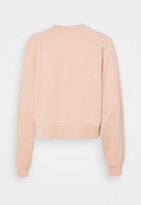 Ljust rosa, kort sweatshirt med raglanärmar. Mjukt material, ribbad halsringning och mudd, slät textur, inga mönster eller detaljer.
