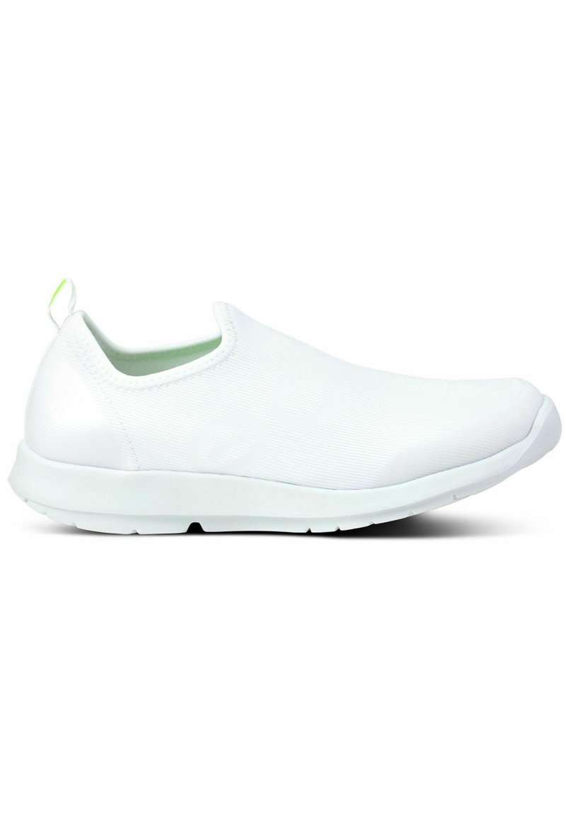White slip-on shoes with a textured upper, rounded toe, and rubber sole. Features a green accent loop on the heel for easy wear.