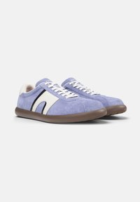 Purple suede sneakers with white leather accents and black detailing. Lace-up closure, round toe, and a brown rubber sole.