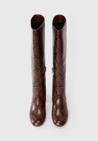 Tall brown knee-high boots with black snake skin pattern and side zippers, shown from front on a white background.