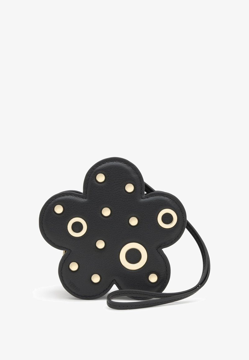 Czarna skórzana torebka w kształcie kwiatu, ozdobiona złotymi ćwiekami i pierścieniami, z cienkim paskiem do noszenia.