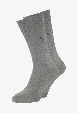 Gray cotton socks with a ribbed cuff and a small logo featuring red, white, and blue stripes. Smooth texture, fitted shape.