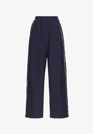 Navy blue wide-leg pants with elastic waistband and white diamond-patterned stripe running down the outer sides of each leg.