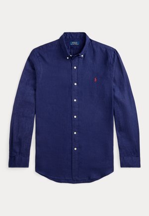 Camisa de botões de manga longa azul-marinho feita de linho. Apresenta um colarinho clássico, botões brancos e um pequeno logótipo vermelho no peito.