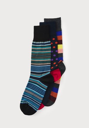 Four pairs of cotton socks: one with blue and black stripes, one with red dots, one solid navy, and one with various horizontal stripes.