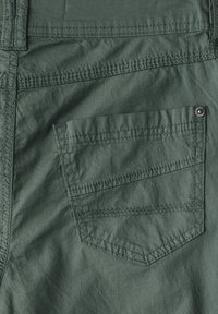 Dark green fabric with a textured surface, featuring a rectangular back pocket, reinforced stitching, and a metal snap detail.
