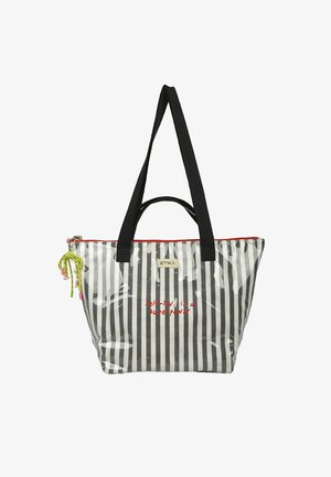 Bolso tote de rayas negras y blancas con asas negras, cremallera roja, adorno verde anudado y texto rojo "el amor propio es un superpoder" en el frente.