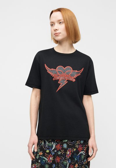 Μαύρο βαμβακερό T-shirt με κόκκινη και λευκή καρδιά από στρας με φτερά και σχέδιο κεραυνού, στρογγυλή λαιμόκοψη και κοντά μανίκια.