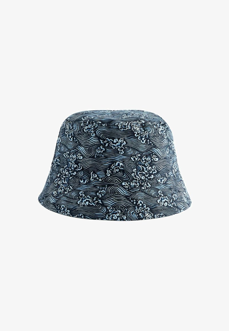 Bucket hat made of fabric with a navy blue background and white swirling wave pattern. Features a wide, downward-sloping brim.