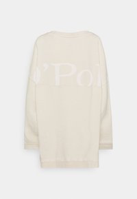 Bluza oversize w kolorze kremowym z okrągłym dekoltem. Na plecach nadrukowany tekst, gładka tekstura i długie rękawy.