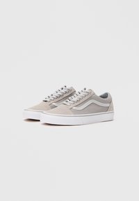 Gray suede low-top sneakers with white rubber soles, featuring metallic silver side accents and textured gray laces.