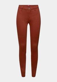 Pantalon skinny taille haute couleur rouille avec passants pour ceinture, bouton à l'avant et fermeture éclair, présenté sur un fond uni gris clair.