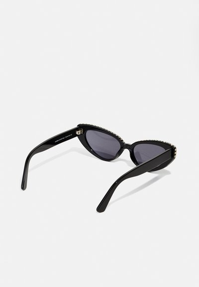 Black cat-eye sunglasses with gradient lenses, featuring a textured rim embellished with small clear jewels and sleek, curved black arms.