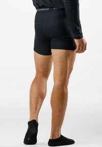 Black boxer briefs made of ribbed fabric feature a wide elastic waistband with 'SWEDEMONT' logo. The design emphasizes fit and comfort.