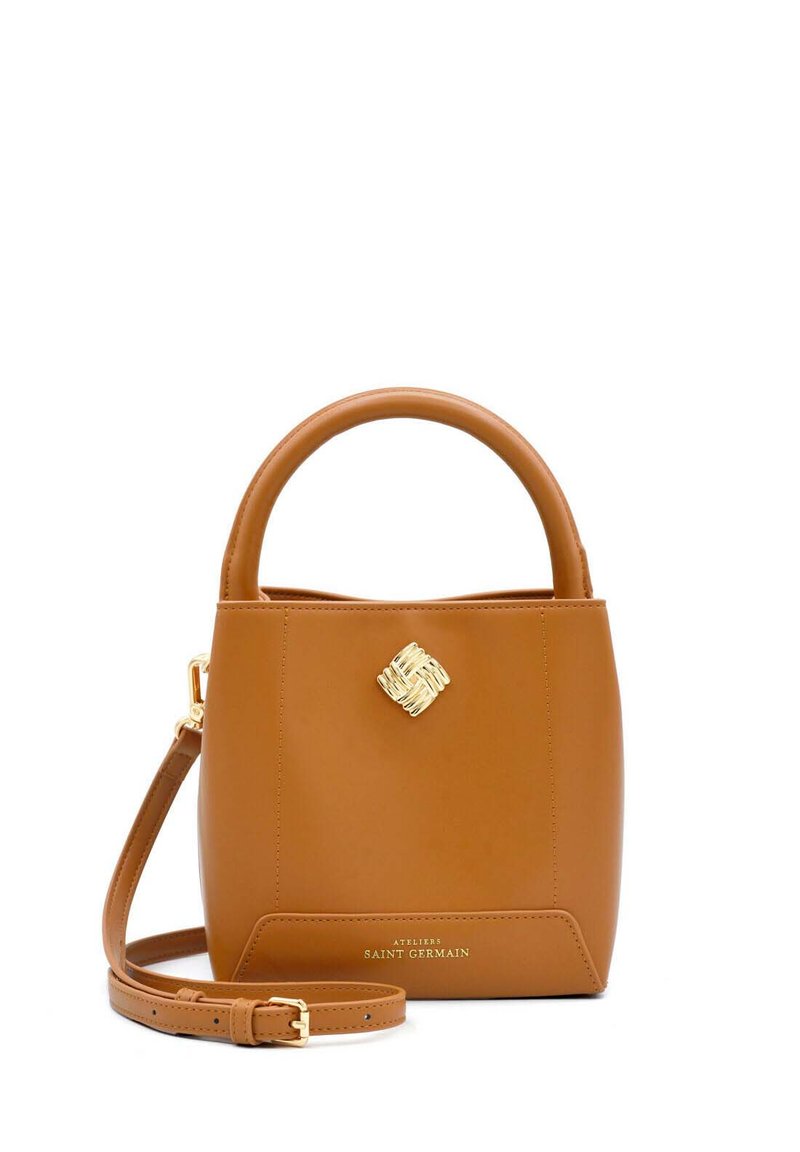 Brown leather handbag with a structured shape, circular handle, gold hardware accent, and removable shoulder strap, featuring logo detail at the base.