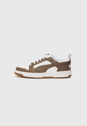 Brown and white sneaker with synthetic upper, perforated toe, and rubber sole. Features laces and a logo accent on the heel.