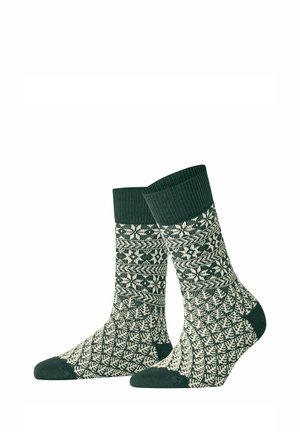 Paire de chaussettes tricotées vert foncé et blanc avec des motifs géométriques et flocons de neige complexes, des bord-côtes et des bouts et talons unis.