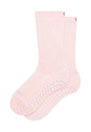 Coppia di calzini grip rosa chiaro con puntini antiscivolo bianchi sulle suole e piccolo logo vicino al bordo superiore.