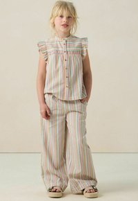 Striped top and wide-leg pants set in light fabric. Features ruffled sleeves, button closure, and colorful horizontal stripes.