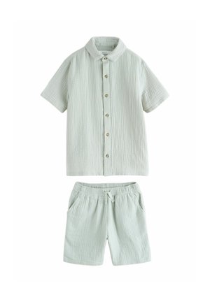 Hellgrünes kurzärmeliges Hemd zum Knöpfen mit elastischen Taillenshorts, beide aus strukturiertem, leichtem Stoff mit dezenten vertikalen Linien.