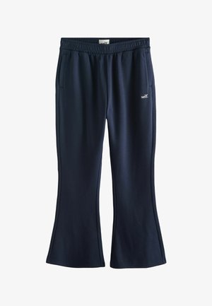 Granatowe dresy o rozszerzanych nogawkach, z elastycznym pasem i dwoma bocznymi kieszeniami. Małe logo "self." po boku.