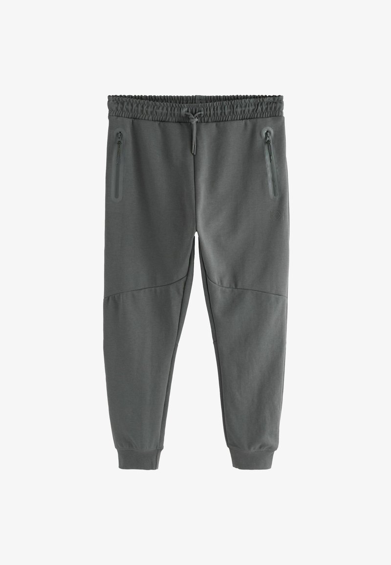 Pilkos sportinės kelnės su tekstūruotu paviršiumi, elastingu liemeniu, raišteliu ir dviem užtrauktukais užsegamomis šoninėmis kišenėmis. Glaudžios rankovės ties kulkšnimis.