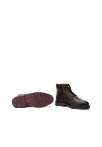 Brown leather ankle boots feature a rounded toe, lace and side zip closures, textured rubber sole, and contrast accents at the collar.