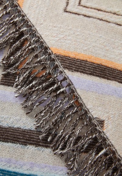 Woven scarf with a textured, soft surface. Features fringe edging, geometric patterns in beige, brown, orange, and lavender hues.