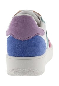 Vit sneaker sedd bakifrån med lila och blå mockapatchar och en vit texturerad sula.