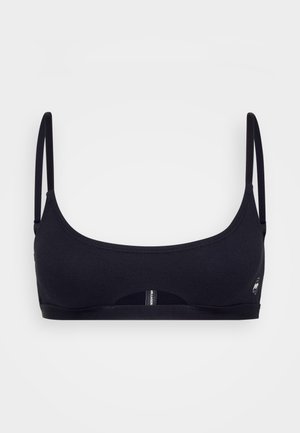 Black sports bra with thin straps, seamless design, stretch fabric, and a small logo detail. Features a snug fit and minimalist style.