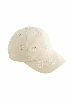 Béžová šiltovka s malými vyšívanými kvetinovými vzormi na korune a šiltu, zobrazená na bielom pozadí.