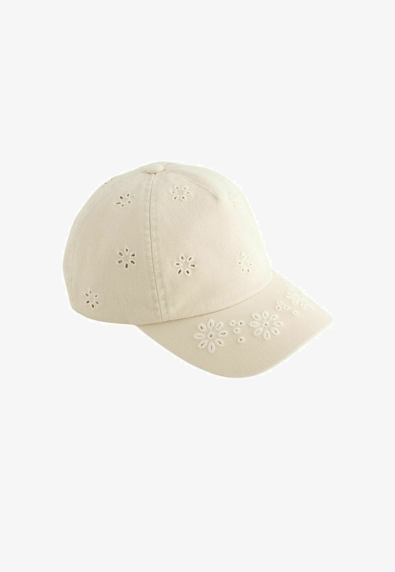 Gorra de béisbol beige con pequeños patrones de flores bordadas en la corona y la visera, mostrada sobre un fondo blanco.