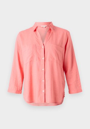 Coral linen shirt with a notched collar, button-front closure, and two chest pockets. Features long sleeves and a slightly curved hem.