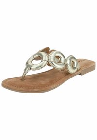 Sandale thong métallique dorée avec trois accents circulaires liés, semelle intérieure douce en tan, semelle plate et couture autour du bord.